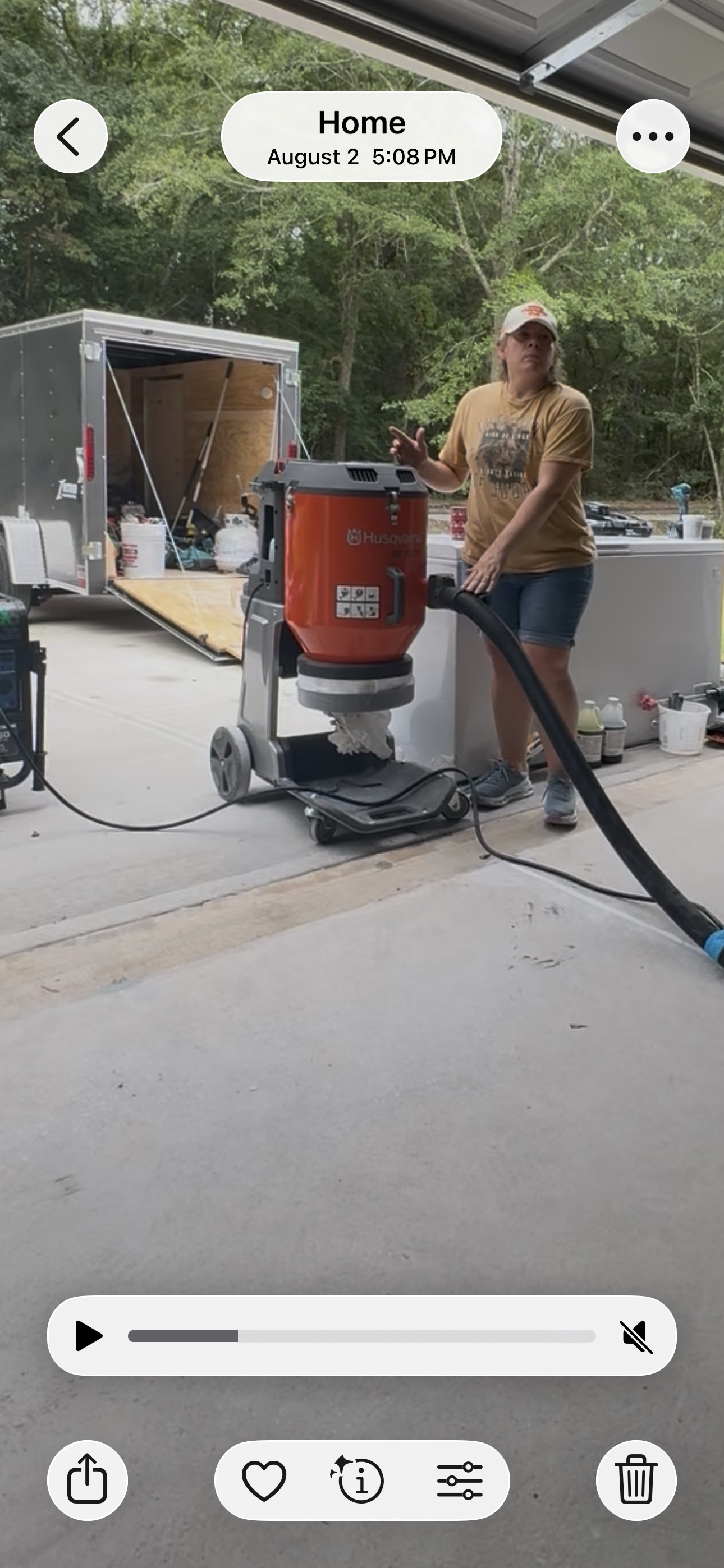 Crew member operating surface-preparation equipment on a garage floor