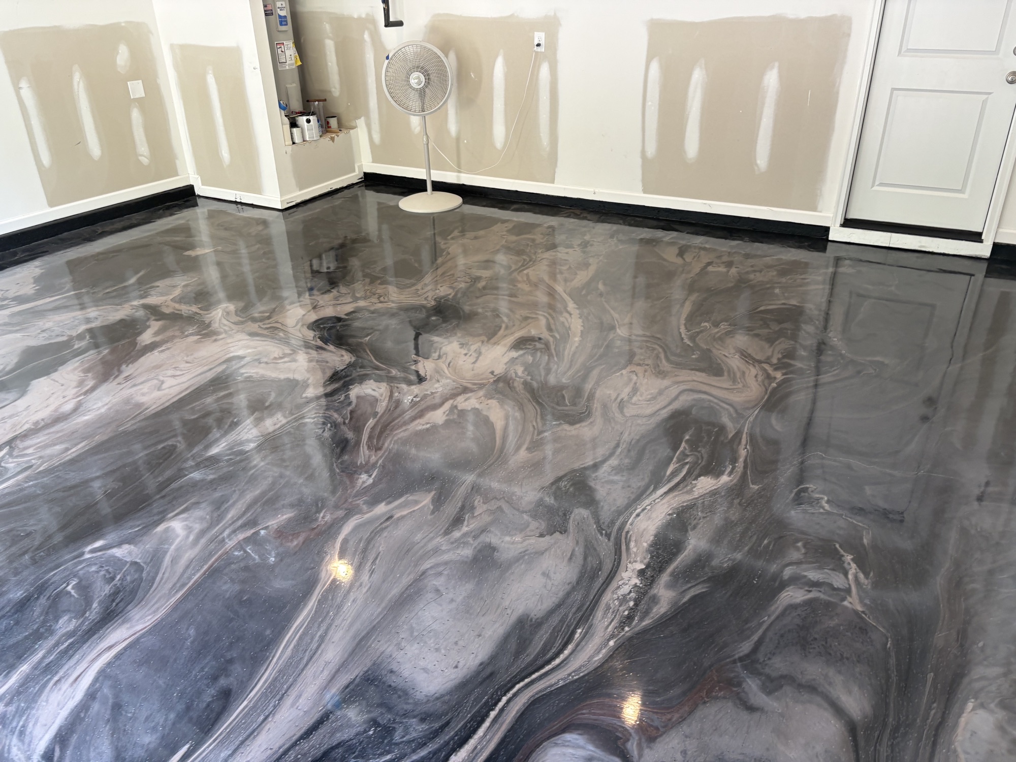 Panoramic view of a reflective gray metallic epoxy garage floor