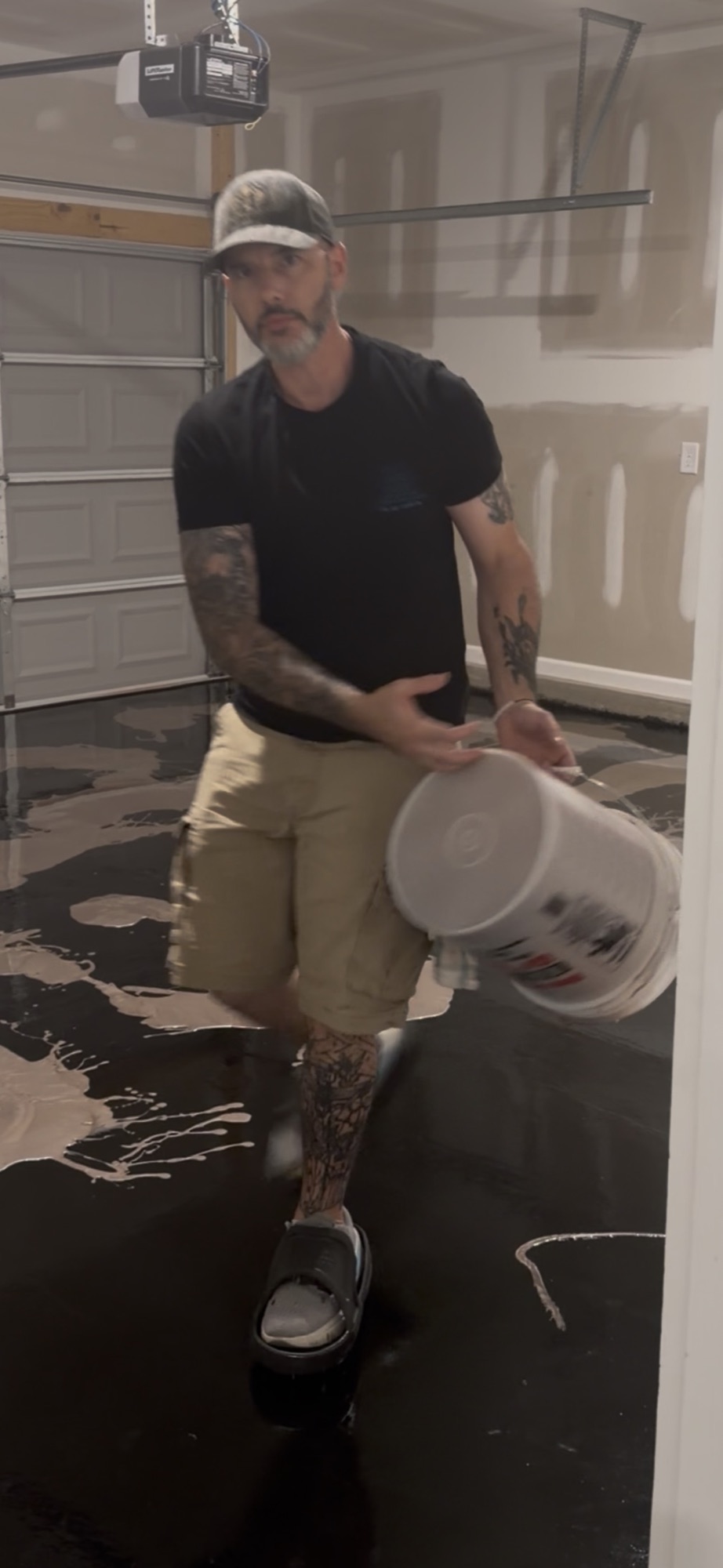 Installer pouring metallic coating material across a garage floor
