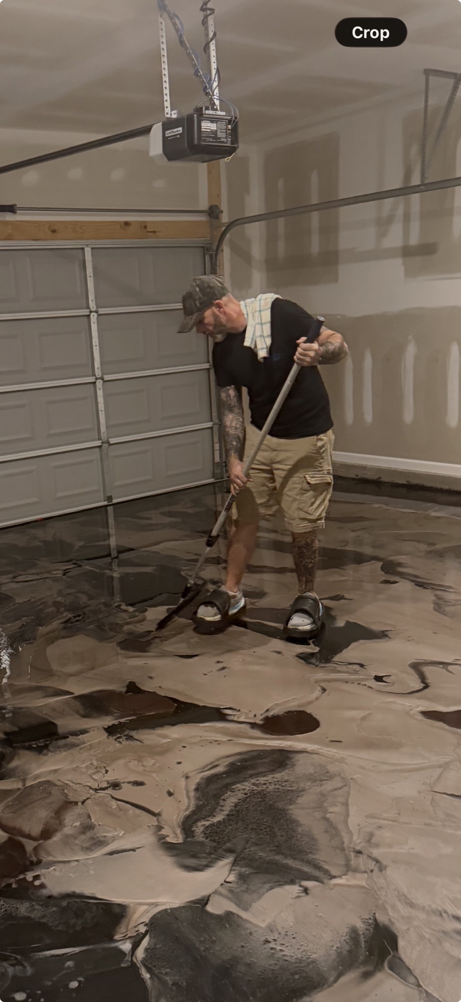 Installer moving metallic coating material with a floor squeegee